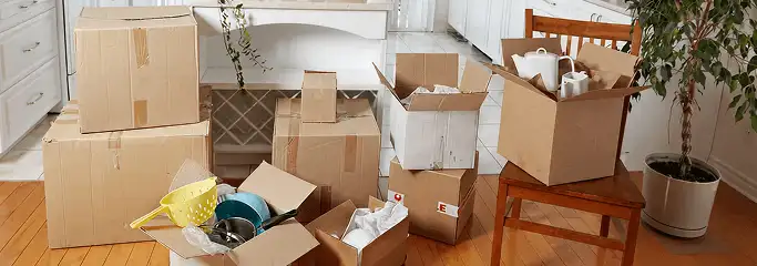 Packed moving boxes and household items in a kitchen before move-out or move-in cleaning, Syracuse, NY.